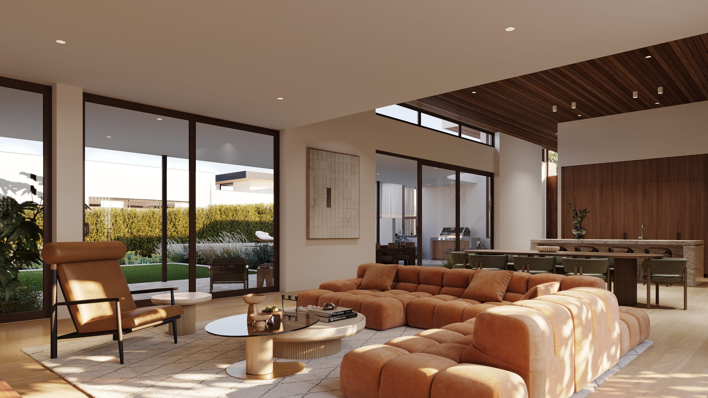 Living space opening through full-height glass to the garden and pool