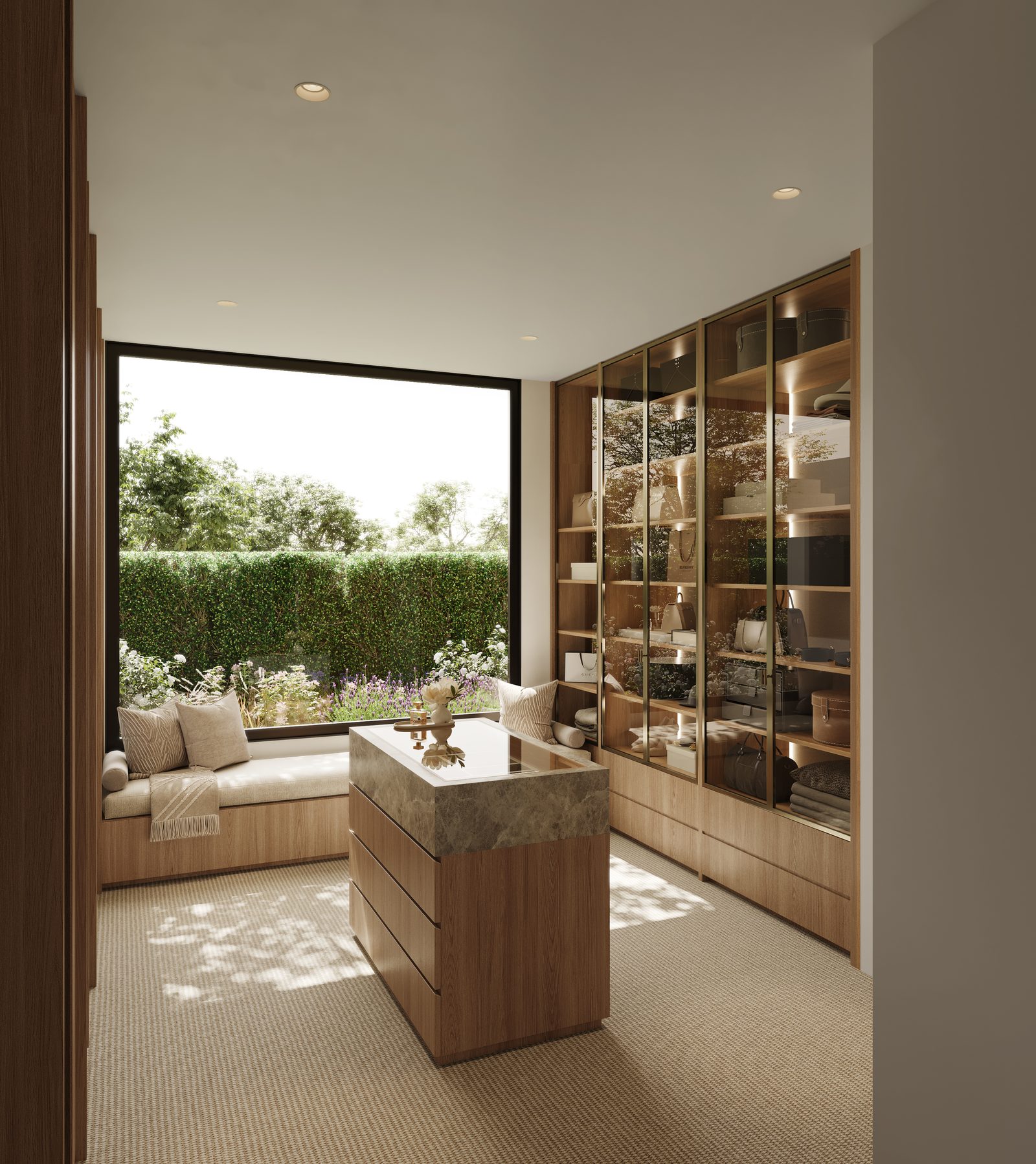 A dressing room with a window seat, garden outlook and glazed cabinetry